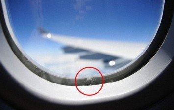 tiny holes in airplane windows