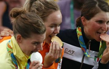 Olympians Bite Their Medals